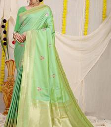 Light green banarasi silk blend saree with zari border & woven buti design