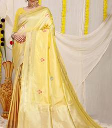 Light yellow banarasi silk blend saree with zari border & woven buti design