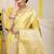 Light yellow banarasi silk blend saree with zari border & woven buti design