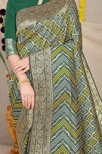 Dark green banarasi silk blend saree with bandhani patola print and zari border