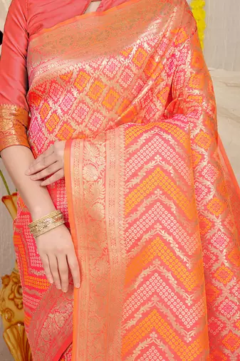 Peach banarasi silk blend saree with bandhani patola print and zari border