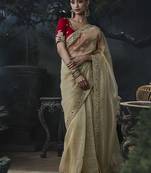 Beige tissue silk blend embroidered saree with red blouse