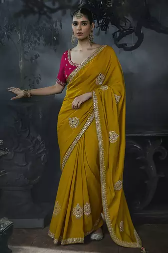 Mustard yellow tissue silk blend embroidered saree with rani pink blouse