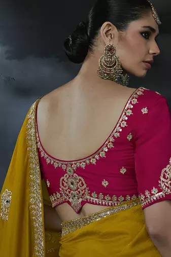Mustard yellow tissue silk blend embroidered saree with rani pink blouse