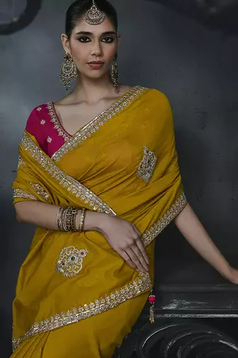 Mustard yellow tissue silk blend embroidered saree with rani pink blouse