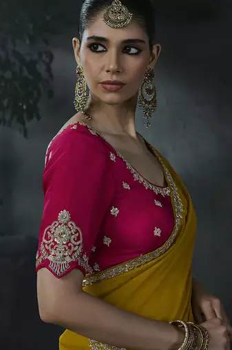 Mustard yellow tissue silk blend embroidered saree with rani pink blouse
