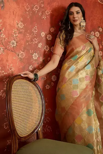 Beige tissue woven design saree with unstitched blouse piece.