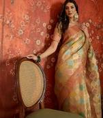 Beige tissue woven design saree with unstitched blouse piece.