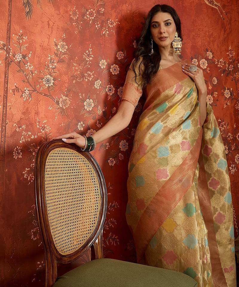 Beige tissue woven design saree with unstitched blouse piece.
