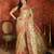 Beige tissue woven design saree with unstitched blouse piece.