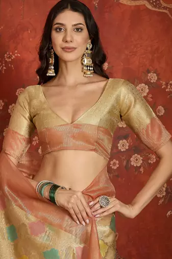 Beige tissue woven design saree with unstitched blouse piece.