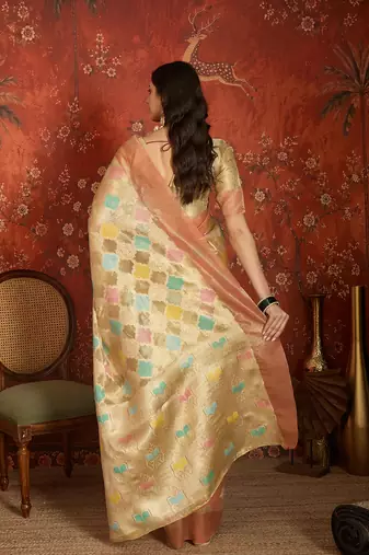 Beige tissue woven design saree with unstitched blouse piece.