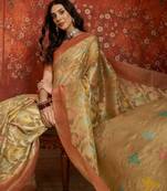 Beige tissue woven design saree with unstitched blouse piece.