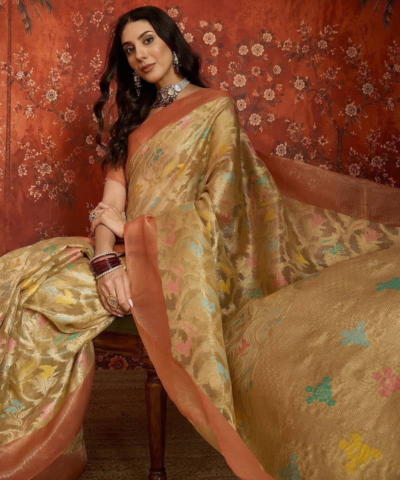 Beige tissue woven design saree with unstitched blouse piece.