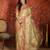 Beige tissue woven design saree with unstitched blouse piece.