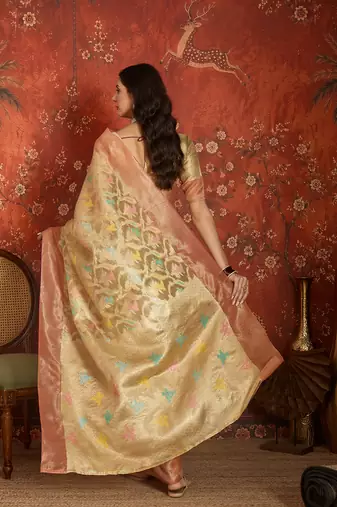 Beige tissue woven design saree with unstitched blouse piece.