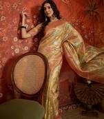 Beige tissue woven design saree with unstitched blouse piece.