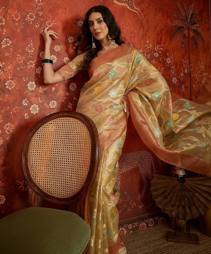 Beige tissue woven design saree with unstitched blouse piece.