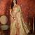 Beige tissue woven design saree with unstitched blouse piece.