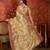 Beige tissue woven design saree with unstitched blouse piece.