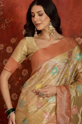 Beige tissue woven design saree with unstitched blouse piece.