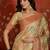 Beige tissue woven design saree with unstitched blouse piece.