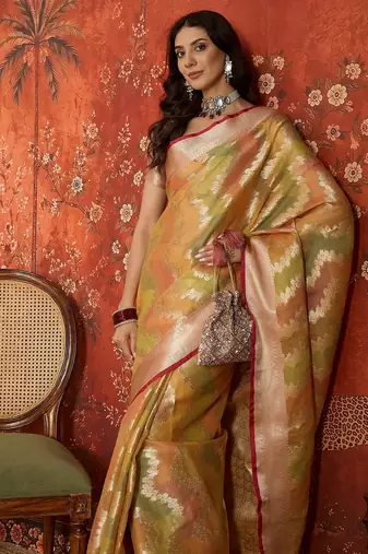 Gold tissue woven design saree with unstitched blouse piece.