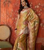 Gold tissue woven design saree with unstitched blouse piece.