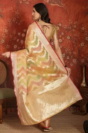 Gold tissue woven design saree with unstitched blouse piece.