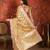 Gold tissue woven design saree with unstitched blouse piece.
