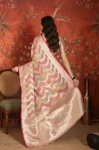 Pink tissue woven design saree with unstitched blouse piece.