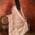 Pink tissue woven design saree with unstitched blouse piece.