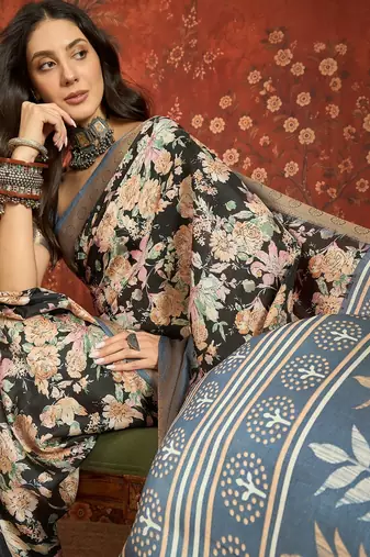 Black silk cotton printed saree with unstitched blouse piece.