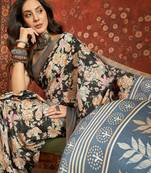 Black silk cotton printed saree with unstitched blouse piece.