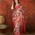 Red silk cotton printed saree with unstitched blouse piece.
