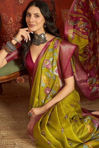 Green silk cotton printed saree with unstitched blouse piece.