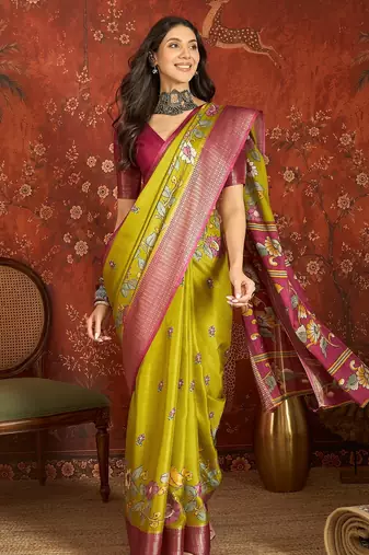 Green silk cotton printed saree with unstitched blouse piece.
