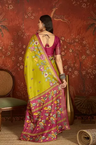 Green silk cotton printed saree with unstitched blouse piece.