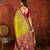 Green silk cotton printed saree with unstitched blouse piece.