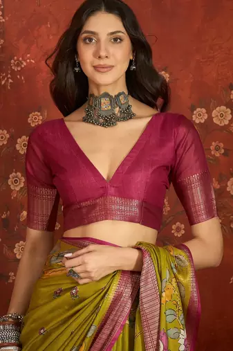 Green silk cotton printed saree with unstitched blouse piece.