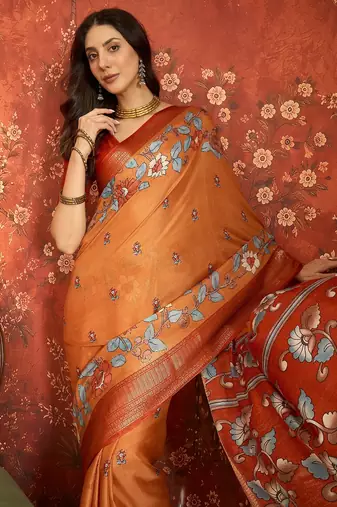 Orange silk cotton printed saree with unstitched blouse piece.