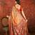 Orange silk cotton printed saree with unstitched blouse piece.