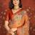 Orange silk cotton printed saree with unstitched blouse piece.
