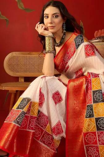 Cream silk cotton bandhni saree with unstitched blouse piece.