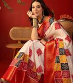 Cream silk cotton bandhni saree with unstitched blouse piece.