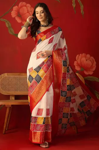 Cream silk cotton bandhni saree with unstitched blouse piece.