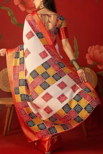 Cream silk cotton bandhni saree with unstitched blouse piece.