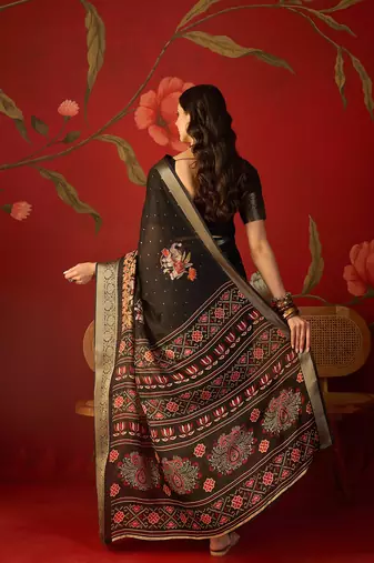 Black chiffon printed saree with unstitched blouse piece.