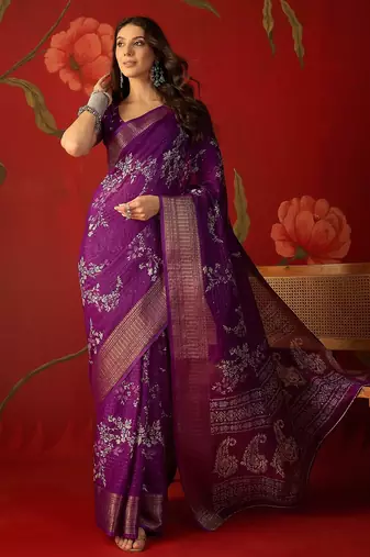 Purple silk cotton printed saree with unstitched blouse piece.
