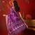 Purple silk cotton printed saree with unstitched blouse piece.